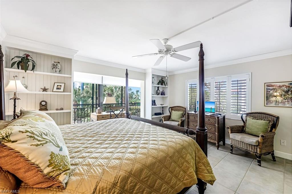 Tiled bedroom featuring access to outside, ornamental molding, and ceiling fan