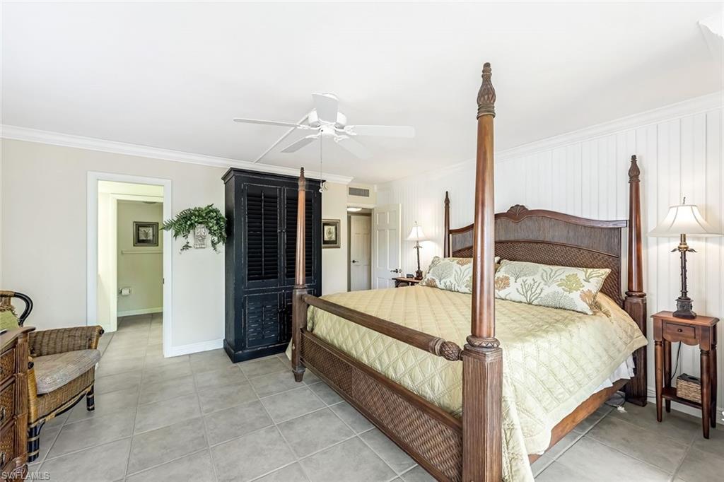 Bedroom featuring crown molding, ceiling fan, and light tile patterned floors