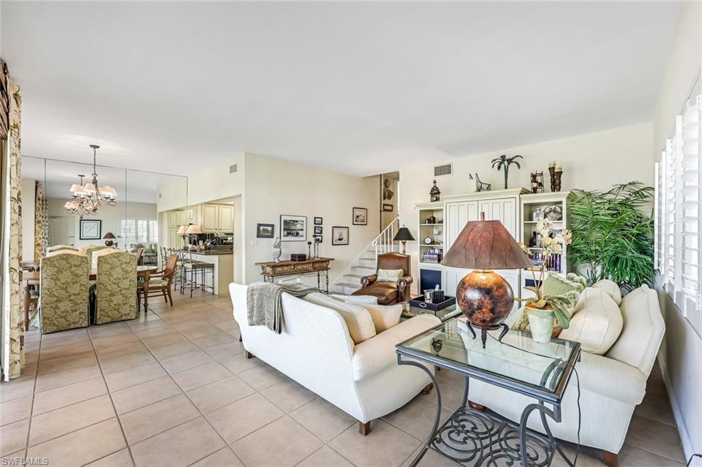 Tiled living room with a chandelier