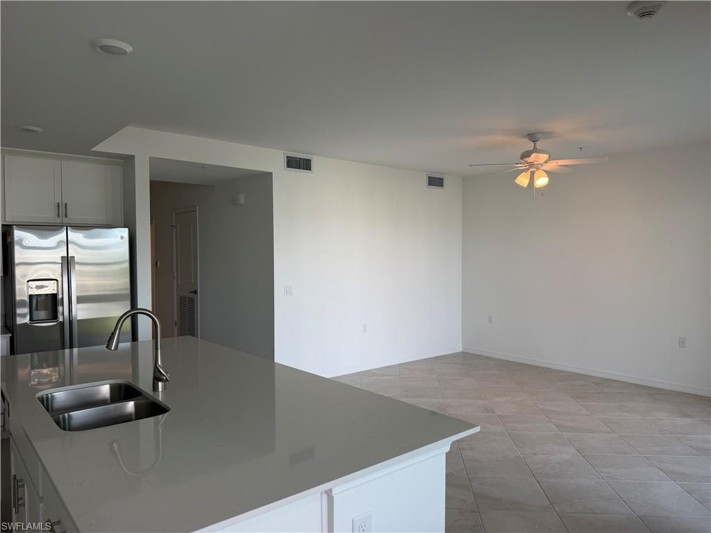 Kitchen island with a double basin stainless steel sink and a contemporary gooseneck faucet