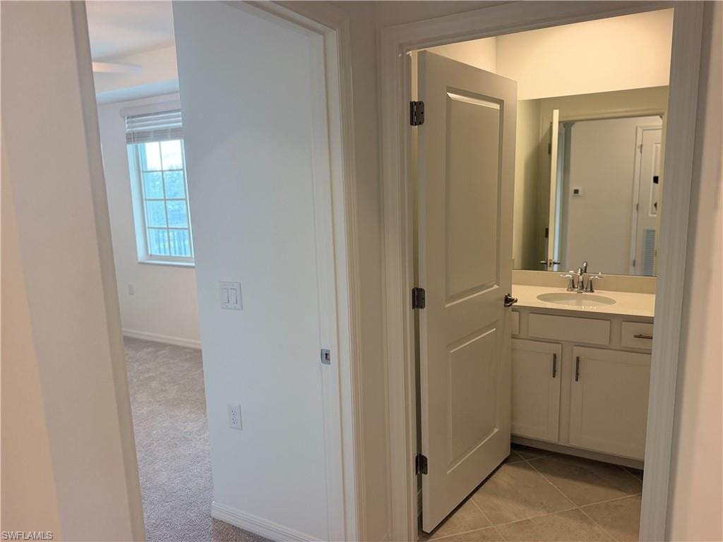 Bathroom 2 vanity featuring a light-colored countertop, undermount sink, and chrome faucet