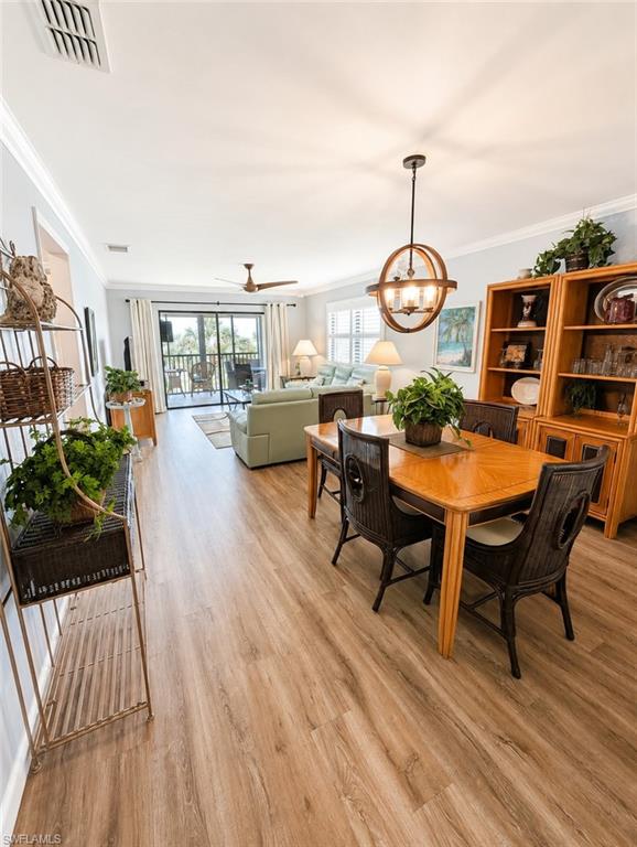 Open-concept living and dining area featuring wood-finish flooring