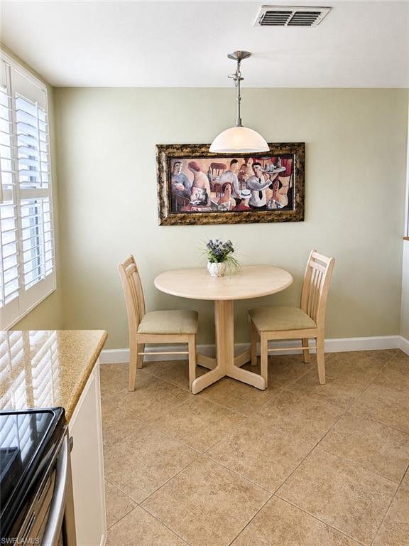 Kitchen nook featuring ceramic tile flooring and light green walls