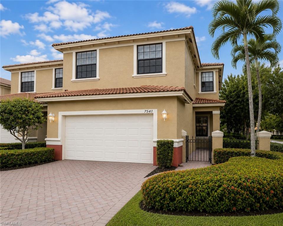Mediterranean-inspired exterior with a terracotta tile roof and stucco finish