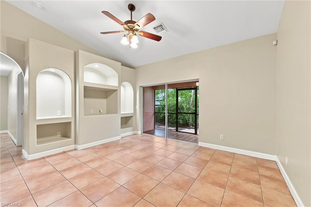 Spacious secondary living area featuring terracotta tile flooring, recessed lighting, and a ceiling fan with integrated light fixture