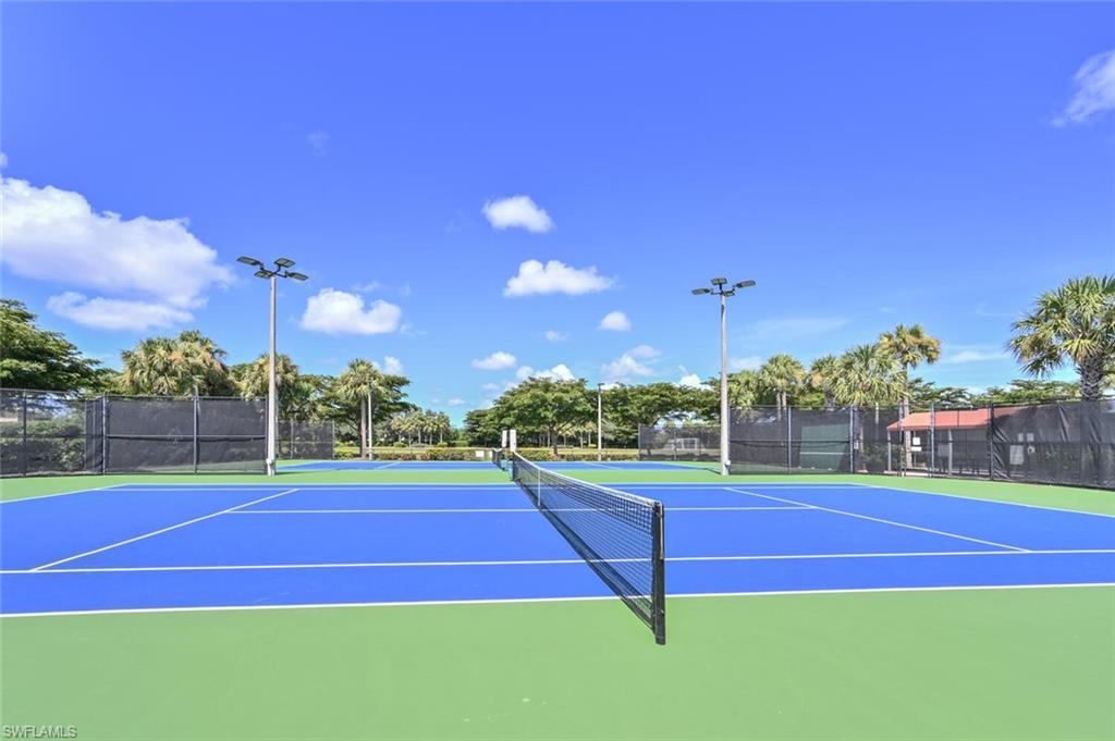 Tennis courts with blue playing surfaces and green out-of-bounds areas