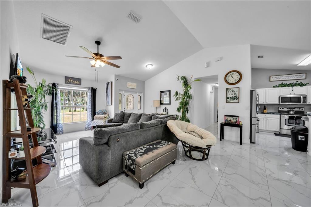 Great room with vaulted ceiling and porcelain tile