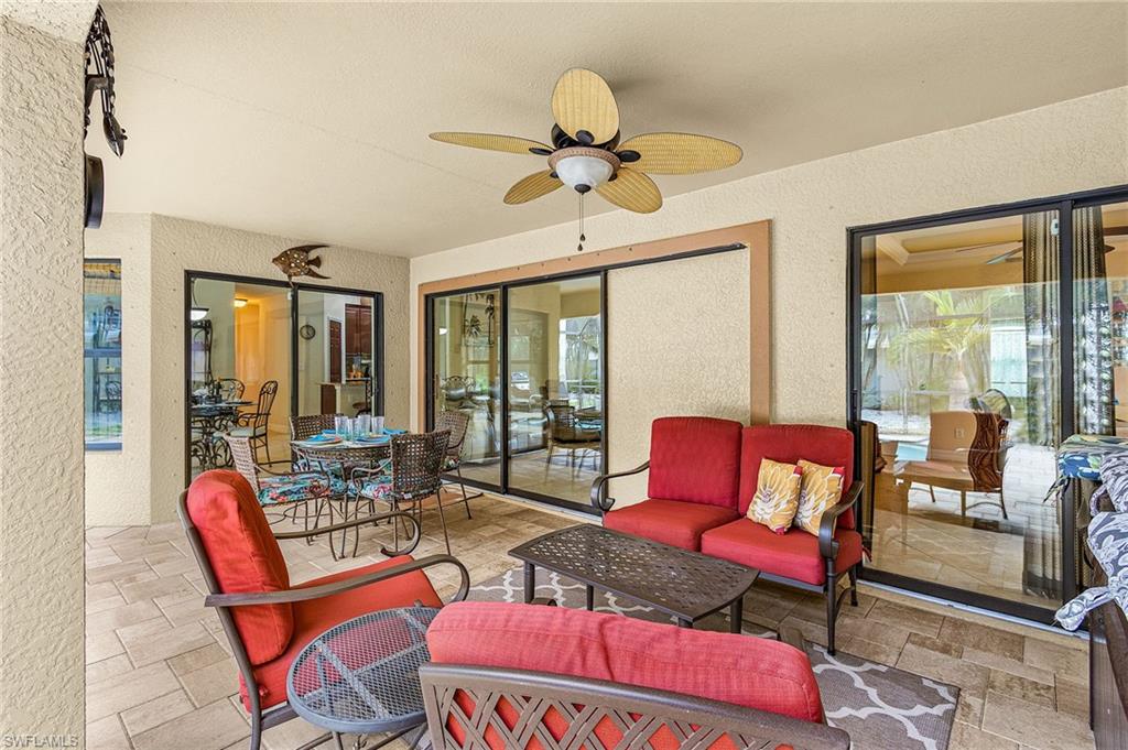 Spacious covered patio featuring ceiling fan, recessed lighting, and tile flooring