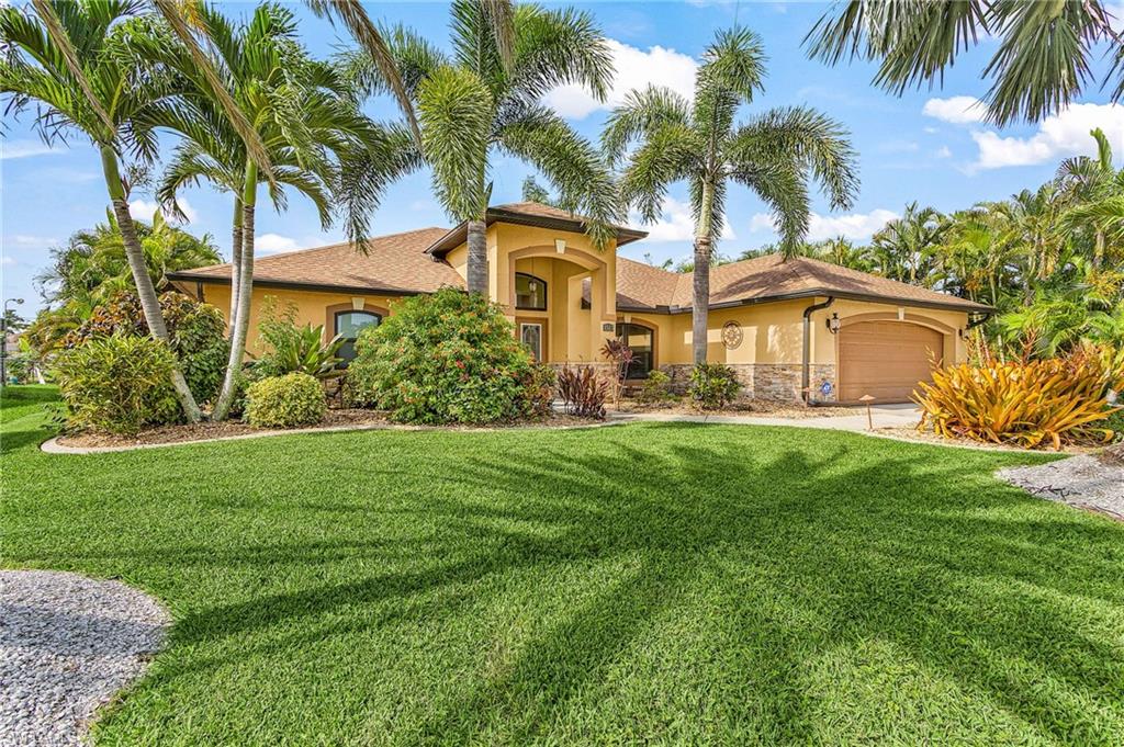Stucco exterior residence with a tiled roof and integrated two-car garage