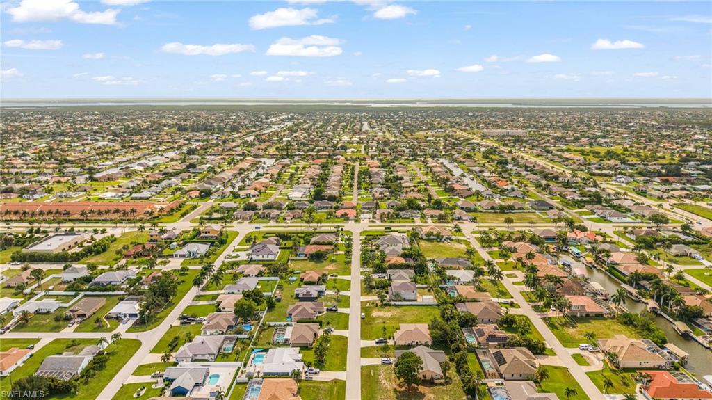 Expansive aerial perspective showcasing a residential development with numerous single-story homes