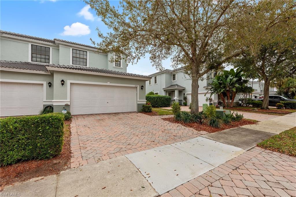 Mediterranean / spanish home featuring decorative driveway, stucco siding, an attached garage, and a tile roof
