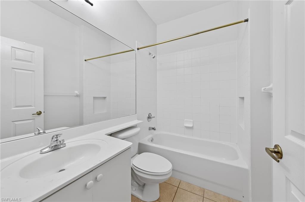 Bathroom featuring vanity, shower / washtub combination, and light tile patterned floors