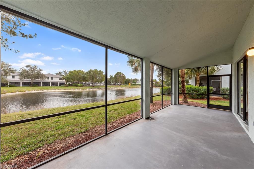 Unfurnished sunroom with a water view and lofted ceiling