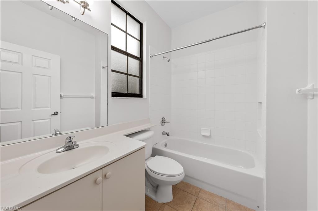Full bathroom with vanity, shower / bath combination, and light tile patterned floors