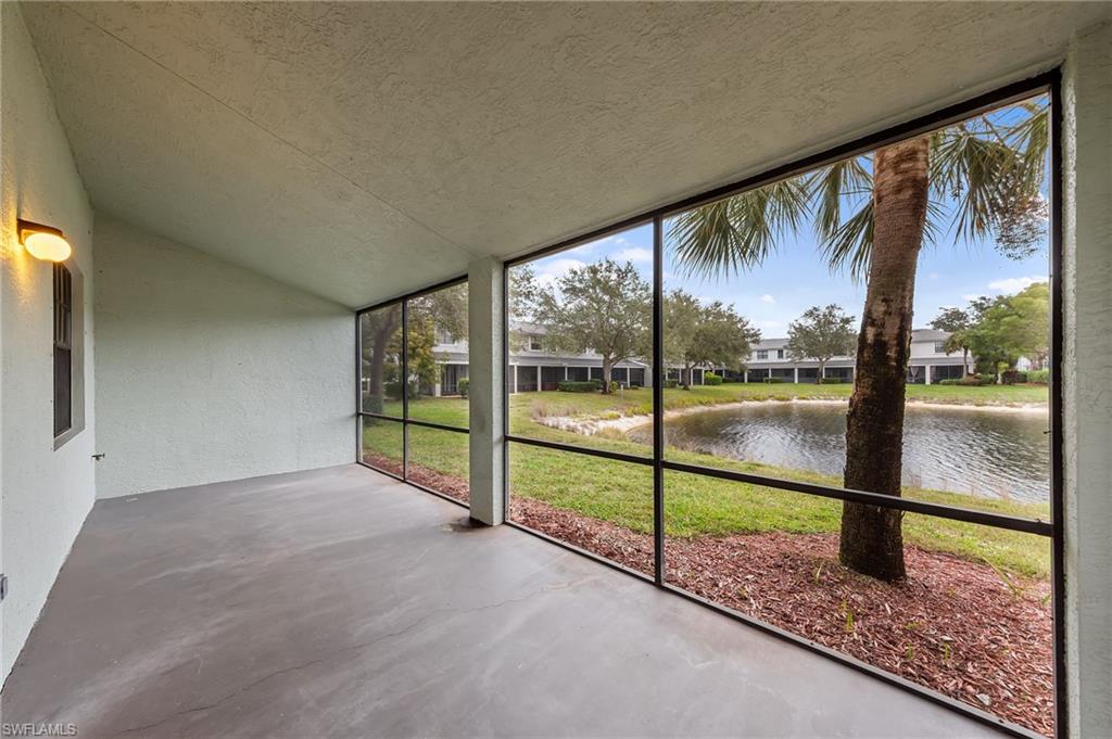 Unfurnished sunroom with lofted ceiling and a water view