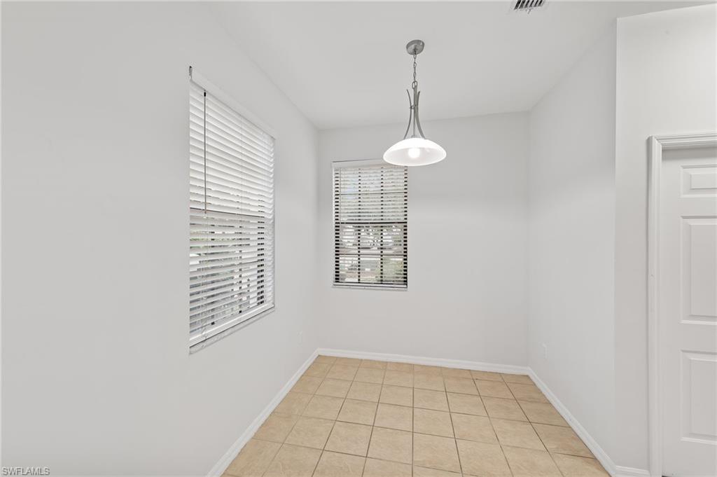 Unfurnished dining area with baseboards and light tile patterned floors