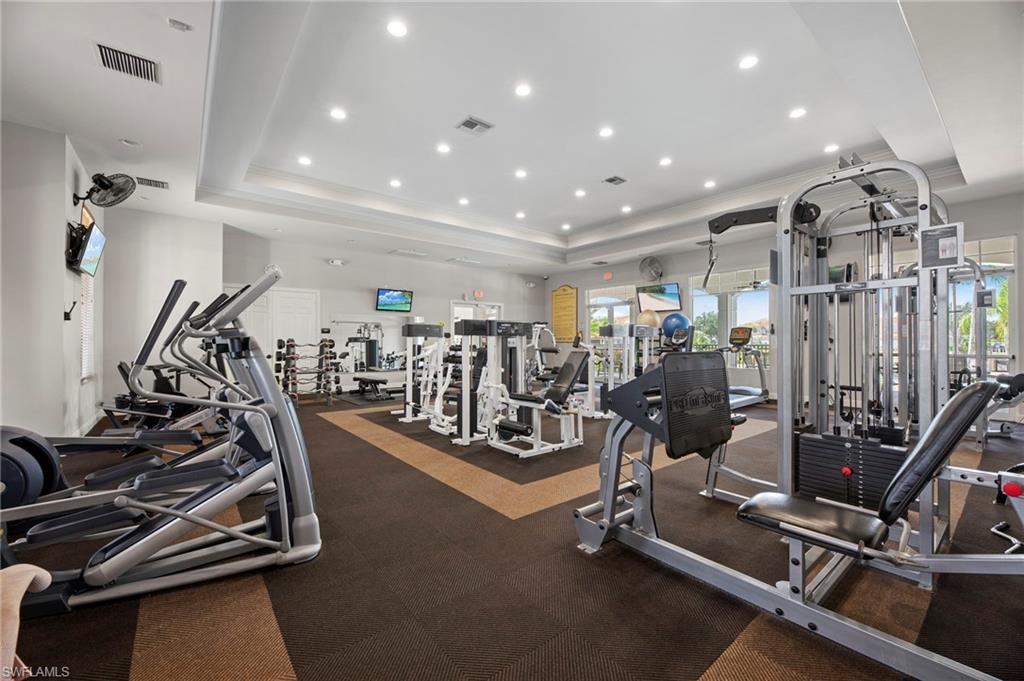 Workout area with crown molding and recessed lighting