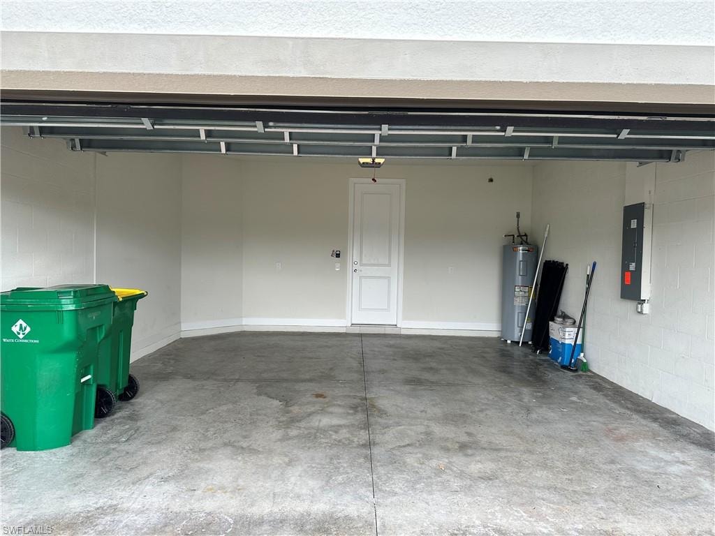 Garage featuring water heater and electric panel