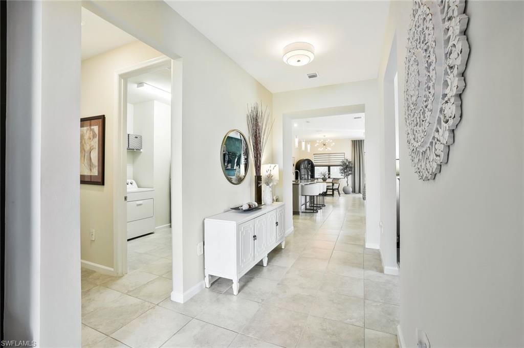Entryway featuring light-toned tile flooring, recessed lighting, and a contemporary ceiling fixture