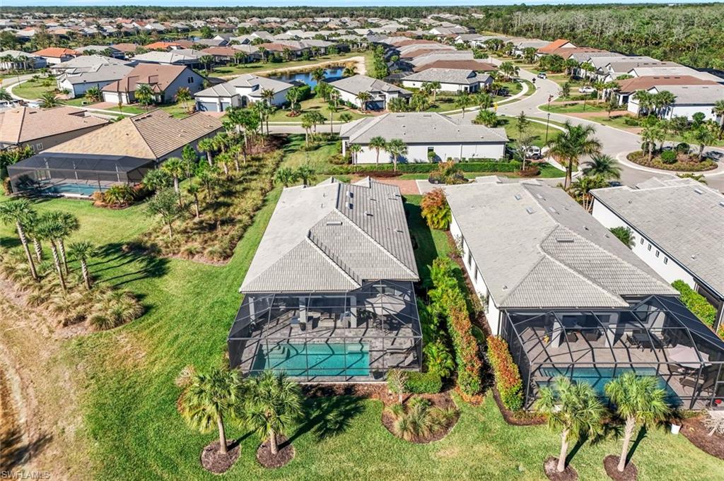 Residential property featuring a screened-in swimming pool and extended lanai