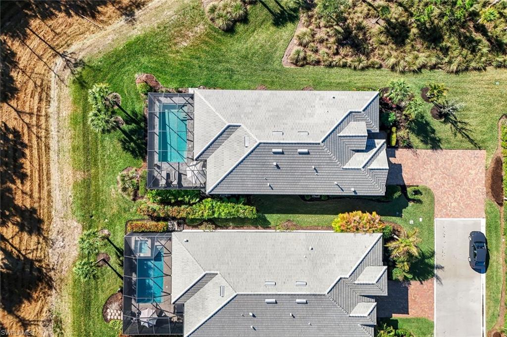Aerial perspective showcasing two properties with private screened pools