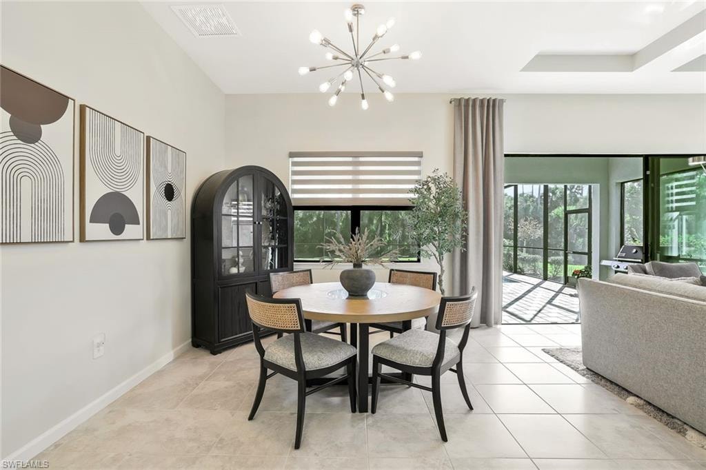 Open-concept dining space featuring neutral-toned tile flooring, a contemporary sputnik chandelier, and a large window with horizontal blinds