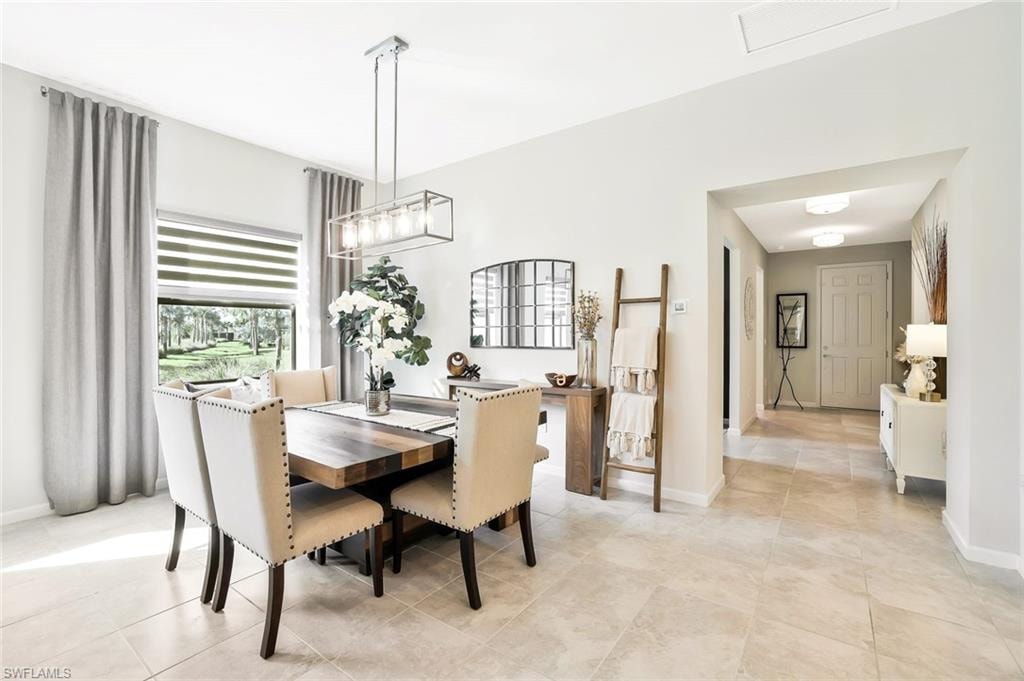 Dining area featuring a contemporary linear chandelier and a picture window