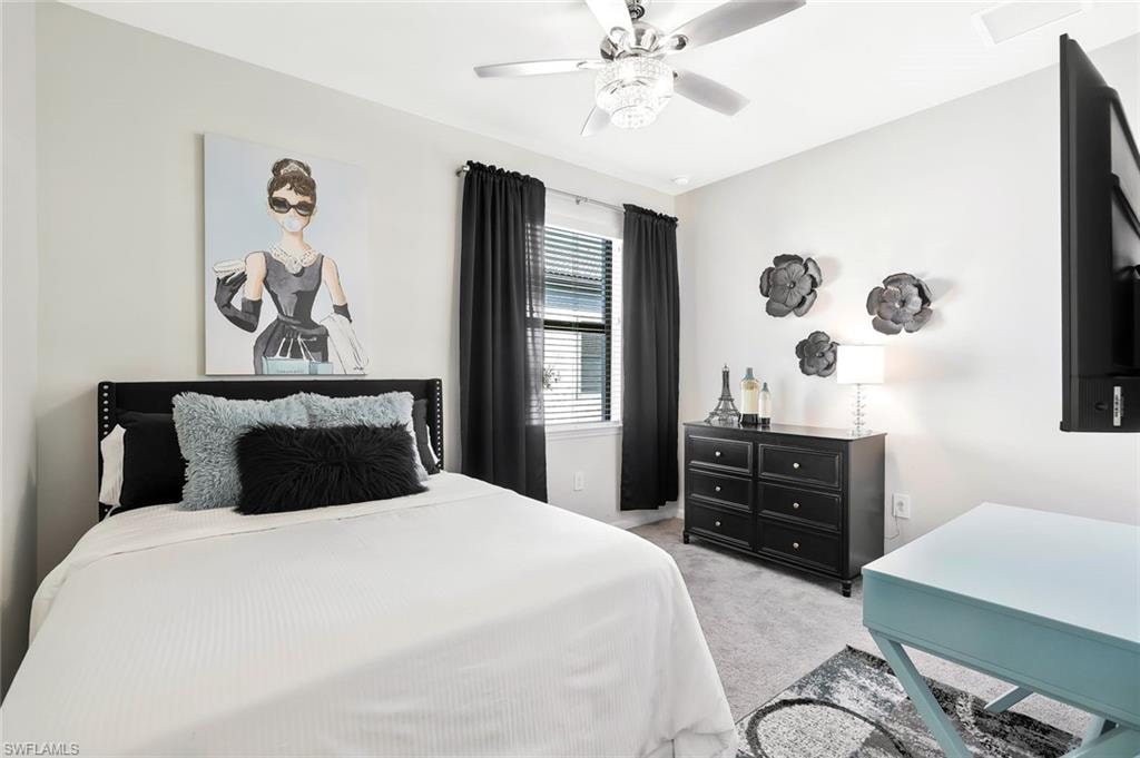 Bedroom featuring light gray wall paint, a ceiling fan with integrated lighting, window with horizontal blinds, and carpeting