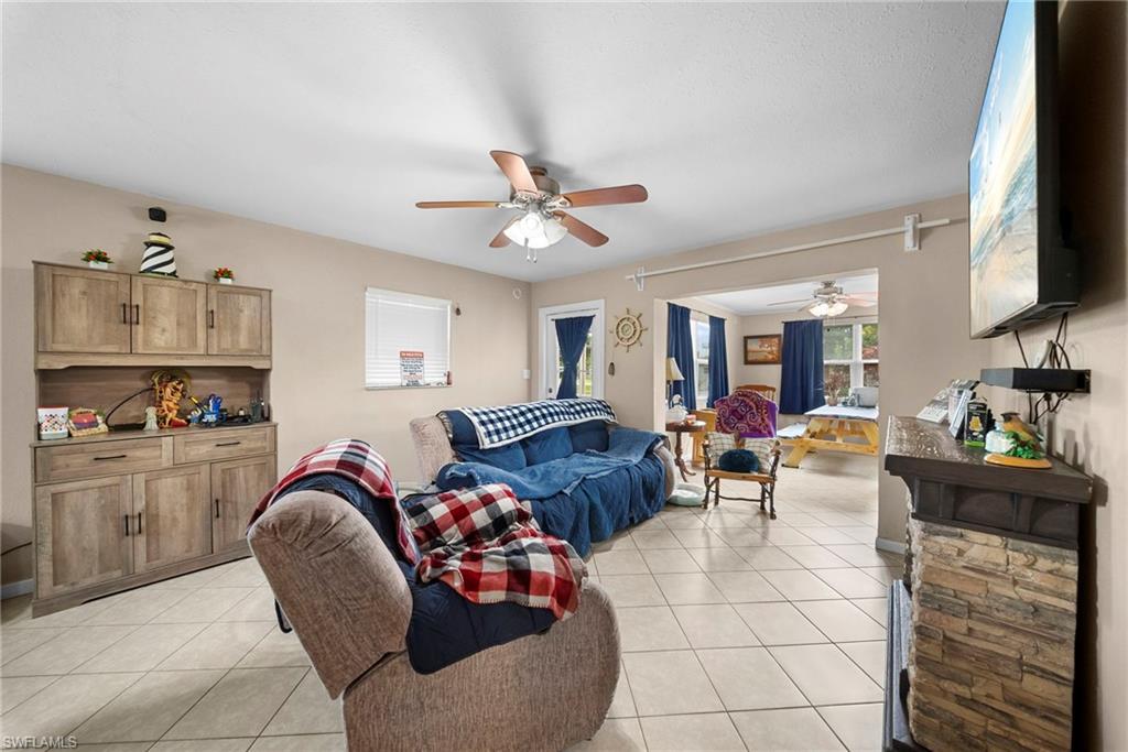 Living area featuring neutral wall tones and light-toned tile flooring