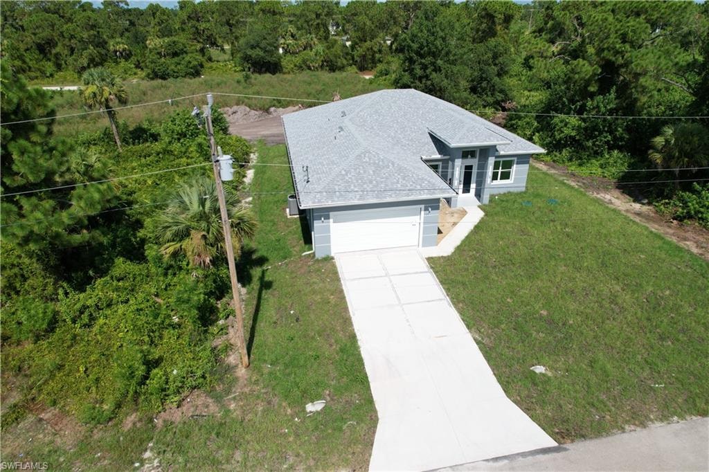 Contemporary single-story residence featuring a light gray exterior and a dark gray shingle roof