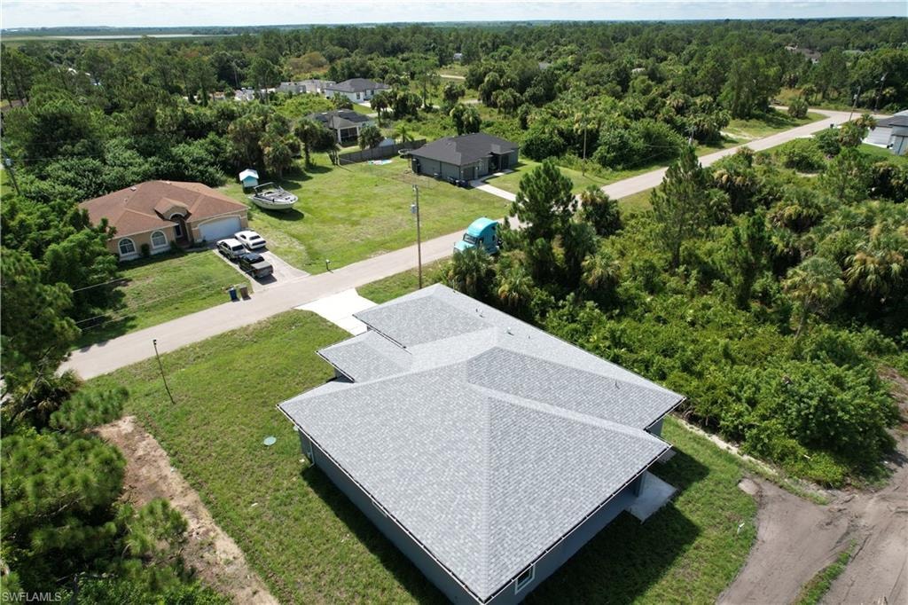 Newly constructed residence featuring a gray shingle roof and a muted blue-gray exterior