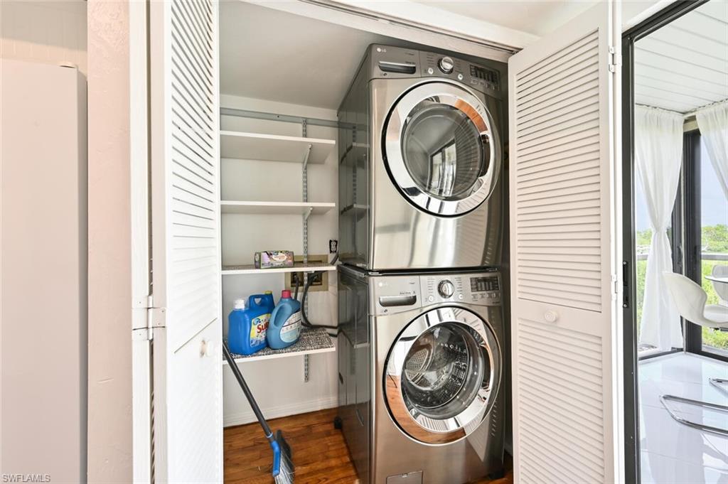 Compact laundry area with stacked stainless steel appliances