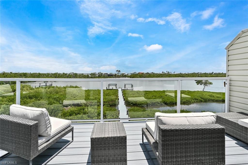 Spacious outdoor deck with composite decking and glass panel railing