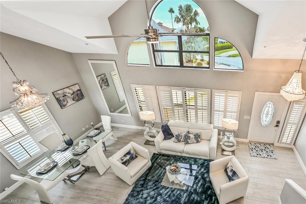 Vaulted ceilings elevate this open living space featuring wood-finish flooring