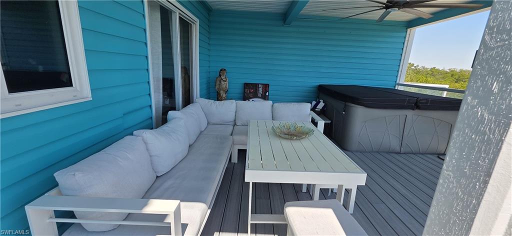 Covered outdoor deck with a built-in hot tub