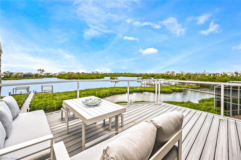 Outdoor deck featuring composite decking and glass panel railings