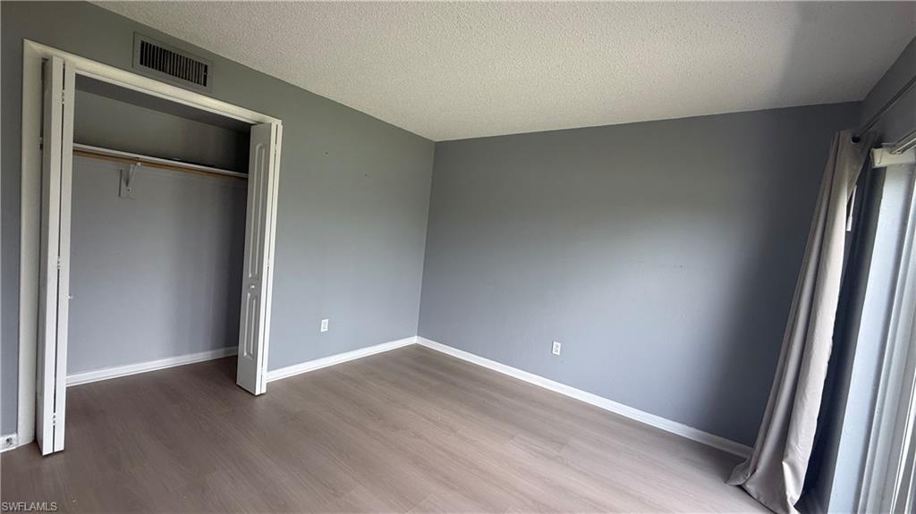 Wood-finish flooring, bi-fold closet, and sliding glass door