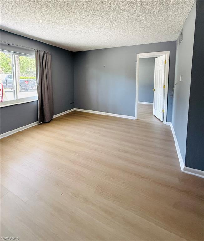 Wood-finish flooring throughout, complemented by a neutral wall palette