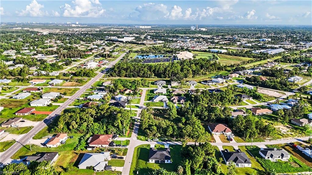 Aerial view showcasing a sprawling residential community featuring generous lot sizes, mature tree-lined properties, manicured green spaces, and well-distributed homes with varied architectural styles