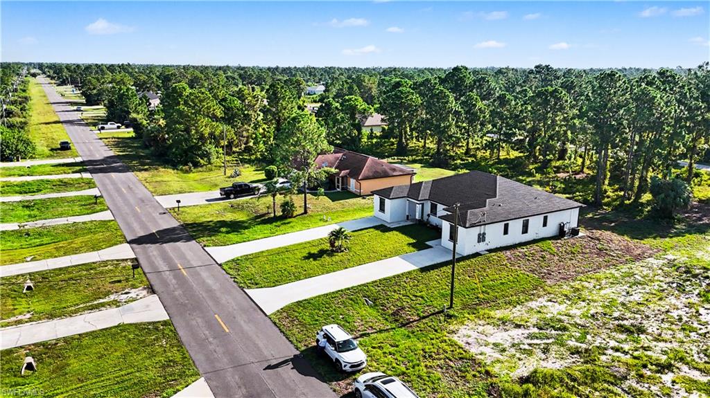 Modern single-story residence with a dark shingle roof and white exterior siding