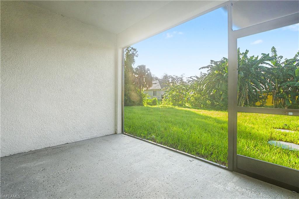 Screened outdoor area with textured white walls and a gray speckled concrete floor
