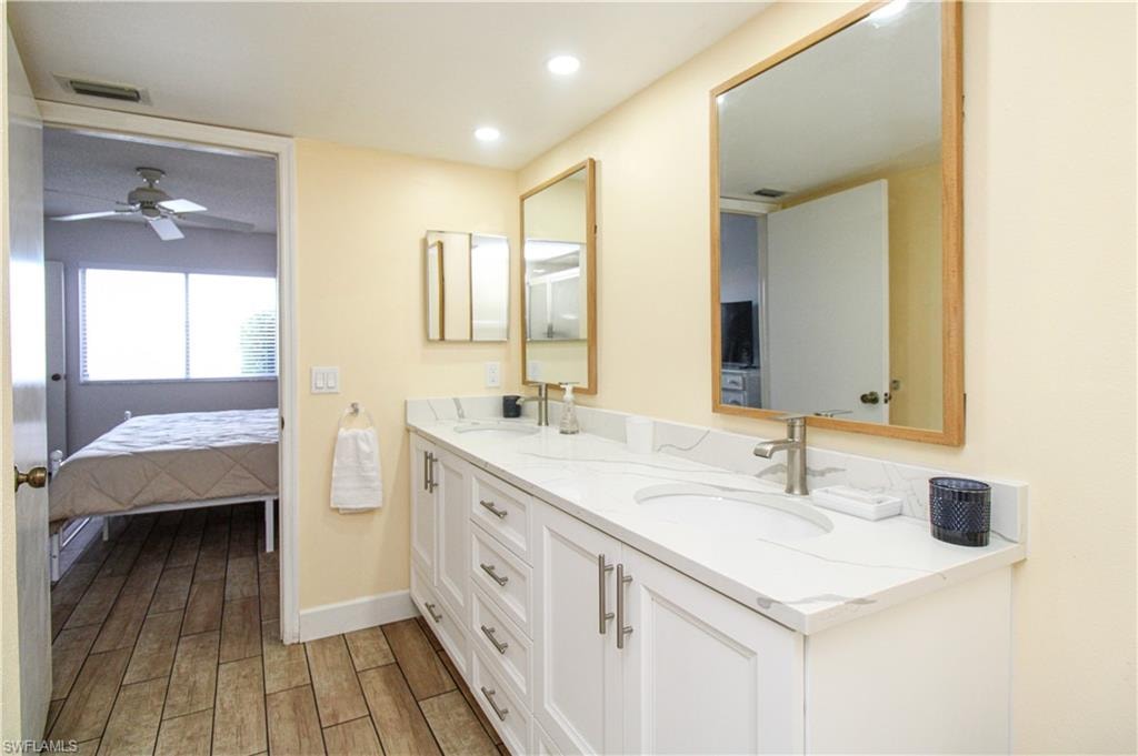 Bathroom with vanity, ceiling fan, and hardwood / wood-style flooring