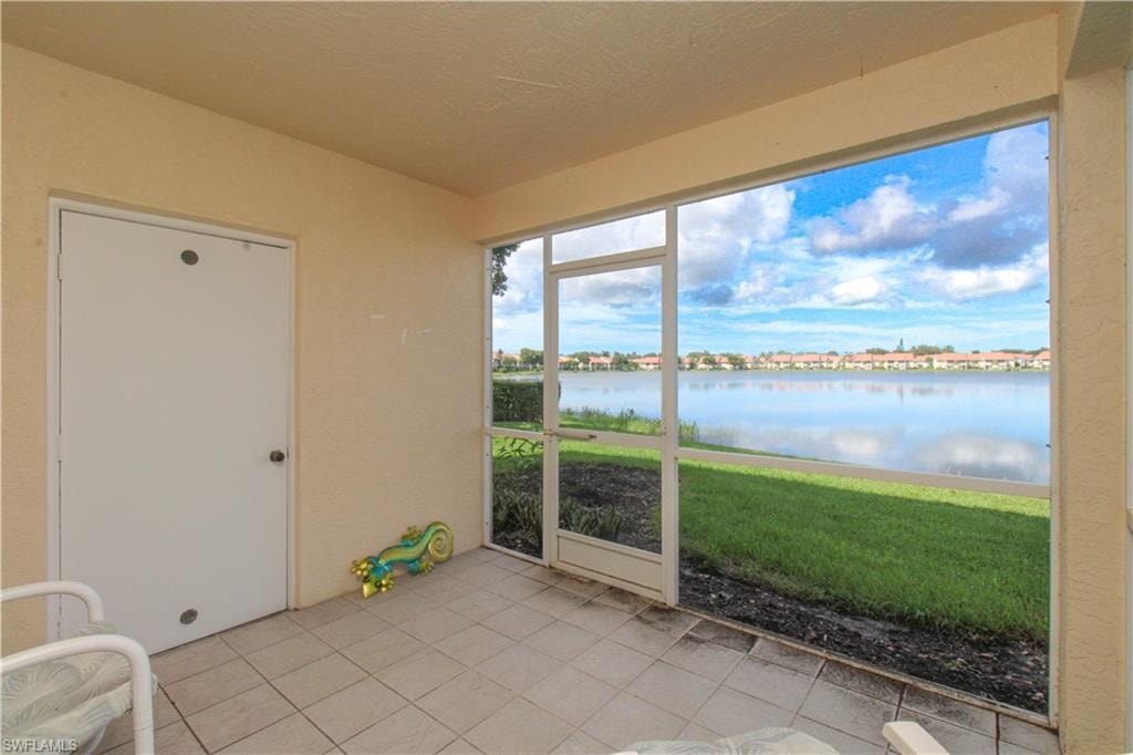 Unfurnished sunroom with a water view