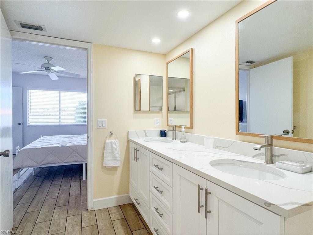 Bathroom featuring wood-type flooring, vanity, and ceiling fan