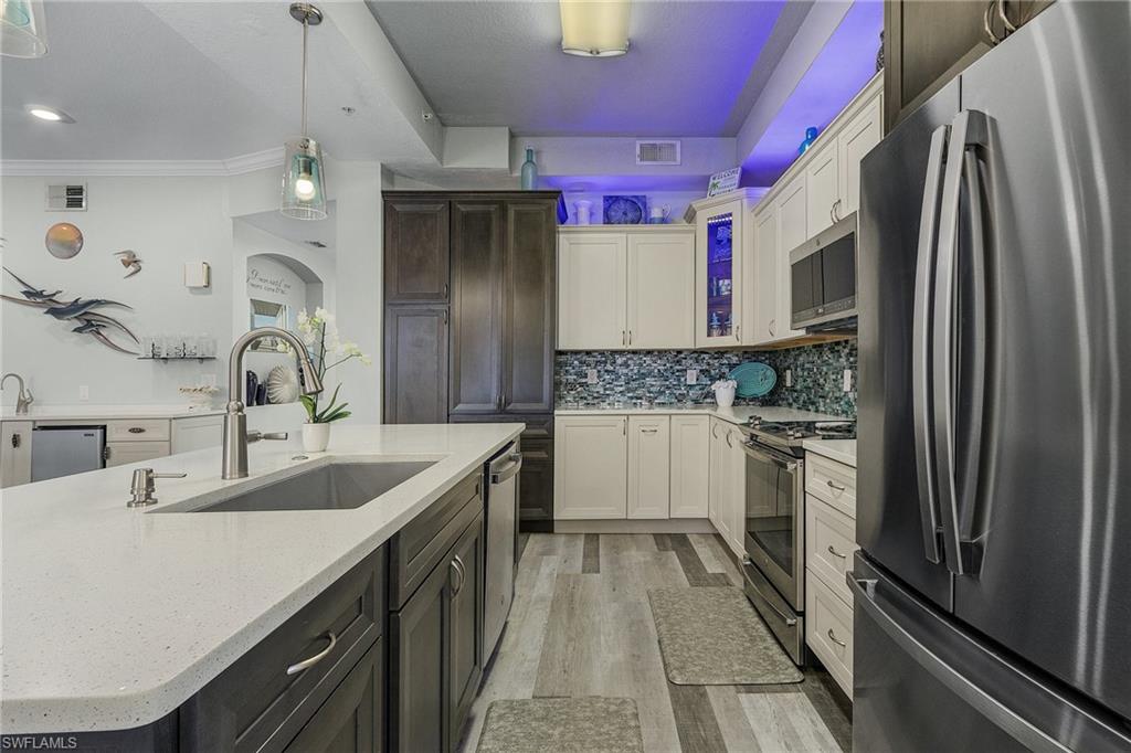 Large kitchen with latest design and appliances open to living areas.