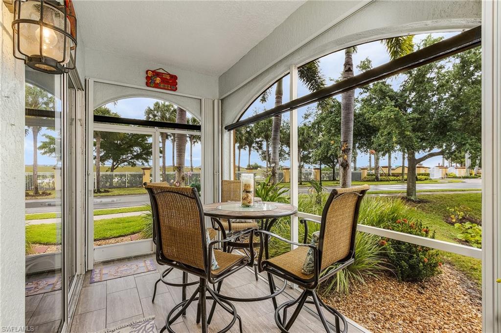 Large lanai overlooks lake and lush landscaping