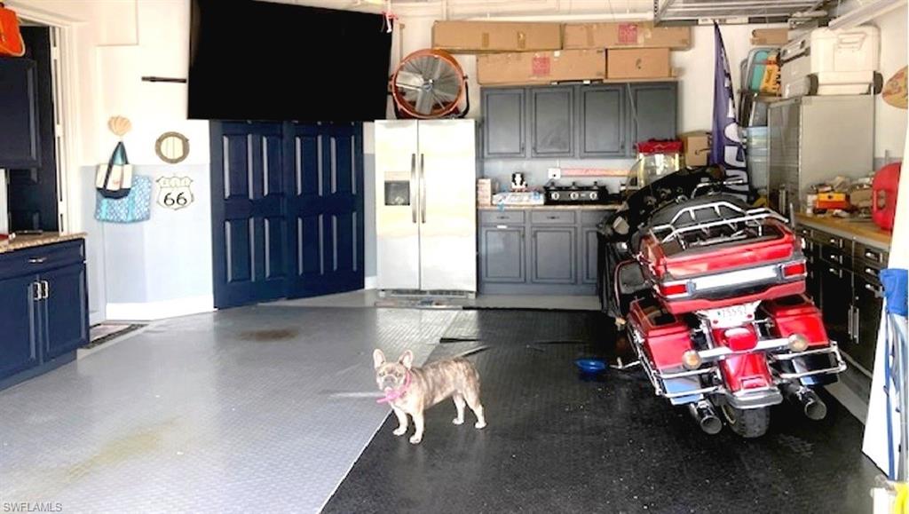 2-car Garage has lots of storage and plenty of "man cave" decor.