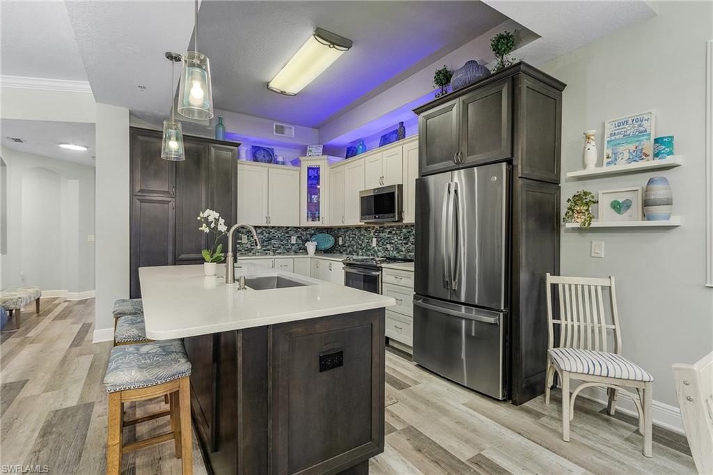 Large kitchen with latest design and appliances open to living areas.