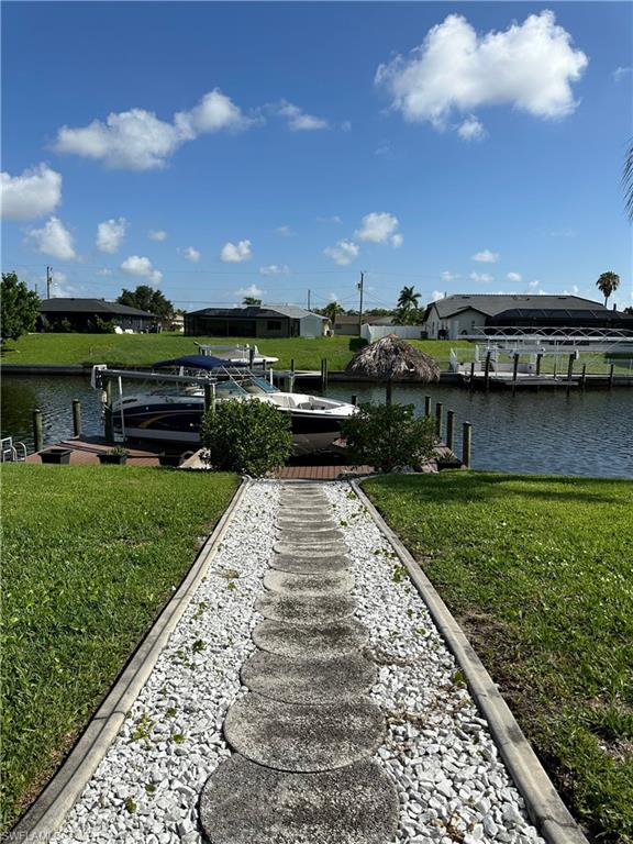 Dock area featuring a water view and a yard