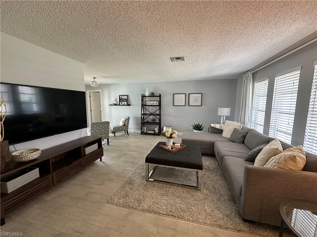 Living room featuring a textured ceiling